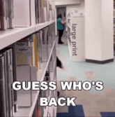 a library with a large print sign in the corner