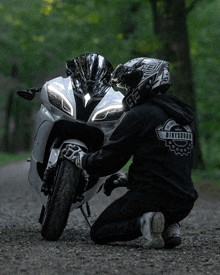 a man wearing a black hoodie that says bike guru