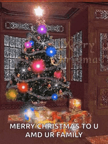 a christmas tree in a living room with the words merry christmas to u and ur family