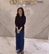 a woman stands in front of a wall that says clinic on it