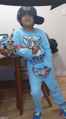 a young boy wearing a blue shirt that says ' too angry '