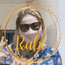 a woman wearing sunglasses and a face mask with the name rubi written in yellow