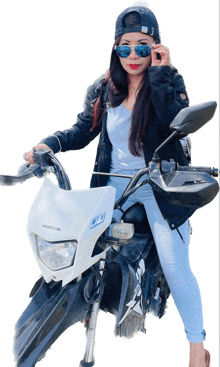 a woman wearing sunglasses and a hat is riding a honda motorcycle