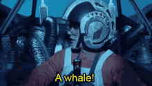 a man in a helmet says a whale while sitting in a vehicle