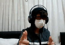 a person wearing headphones and a mask with something on their shirt