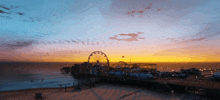 a pier with a ferris wheel in the middle of it