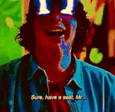 a man in a blue shirt is laughing and saying sure have a seat mr.