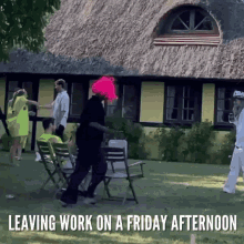 a group of people are dancing in front of a thatched house with the caption leaving work on a friday afternoon