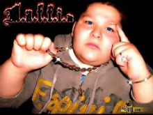 a young boy wearing a necklace with the name a.l.a.f.f.i.a. written on it