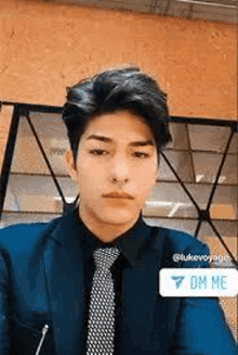 a man in a suit and tie is sitting at a table .