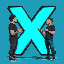 two men are standing in front of a blue letter x