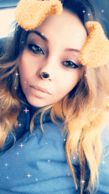 a woman wearing a snapchat filter that looks like a dog 's nose