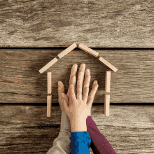 a house made out of wooden blocks on a wooden floor