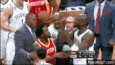 a group of basketball players are standing on a court and one of them is wearing a jersey that says houston .