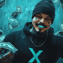 a man wearing a black hoodie with a blue x on it holds a stack of money