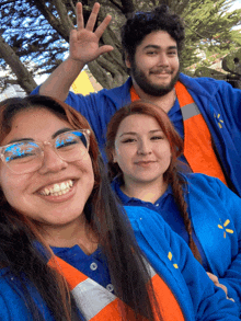 a group of people wearing walmart uniforms pose for a picture