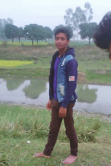 a boy wearing a purple shirt and a blue jacket with an american flag patch