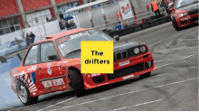 a red and black car with the words the drifters on it