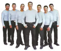 a group of men standing next to each other in a row