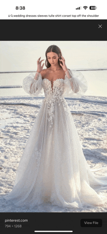 a woman in a white wedding dress is on the beach