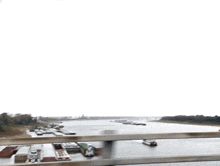 a bridge over a body of water with a few boats in it