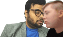 a man with glasses and a beard kisses another man