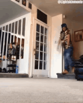 a man is standing in a living room with the words lightskinmonte on the bottom