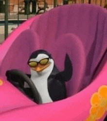 a penguin wearing sunglasses is sitting in a pink carnival ride .