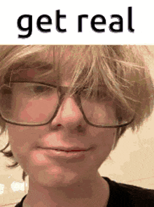 a close up of a person wearing glasses and a wig .