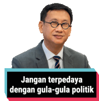 a man in a suit and tie with a sign that says jangan terpadaya dengan gula-gula politik