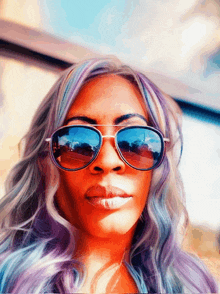 a woman with purple hair is wearing sunglasses with a blue lens