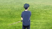 a boy and a girl are playing with sticks in a field