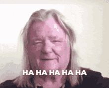 a man with long blonde hair is laughing with the words `` ha ha ha ha '' written on the bottom .