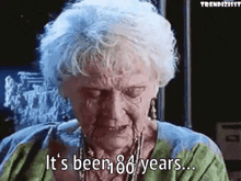 an elderly woman is crying and saying `` it 's been 100 years ... '' .