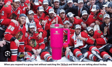 a group of hockey players are posing for a picture with a pink stanley mug