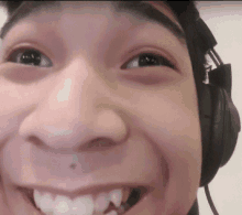 a close up of a person 's face with headphones