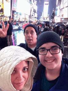 a group of people are posing for a picture in a crowded city street