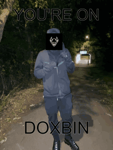 a man standing on a sidewalk with the words you 're on doxbin behind him