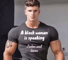 a man with a black shirt that says a black woman is speaking listen and learn