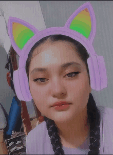 a girl wearing purple headphones with cat ears on her head