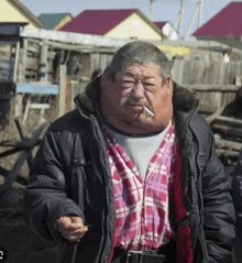 a man smoking a cigarette with a large neck