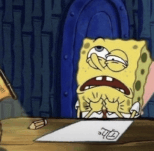 a cartoon character named spongebob is sitting at a table with a piece of paper on it