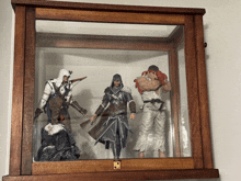 a display case with three action figures including ryu