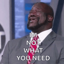 a man in a suit and tie is laughing and saying i 'm not what you need