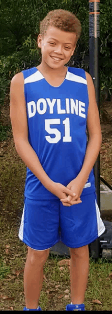 a boy wearing a blue doyline 51 jersey