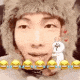 a man wearing a furry hat is holding a stuffed bunny .