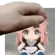 a hand is holding a stuffed doll with pink hair and blue eyes .