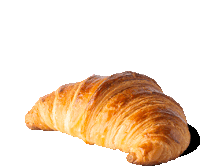 a croissant is sitting on a white surface