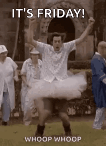 a man in a tutu is jumping in the air while a group of people watch .