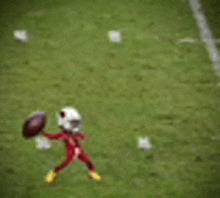 a mascot is holding a football in his hands on a field .